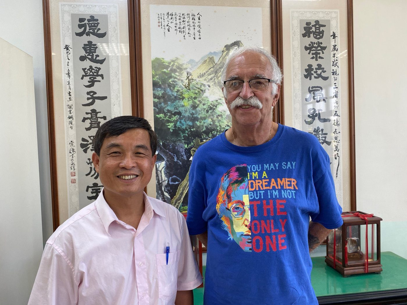 Grandpa Mike before the calligraphy scrolls he loved, at a Taiwanese school
