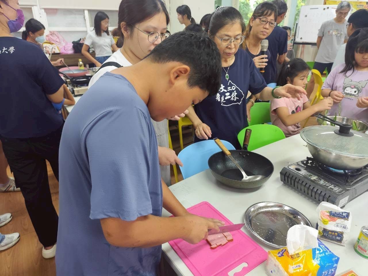 A student carefully preparing ingredients for cooking