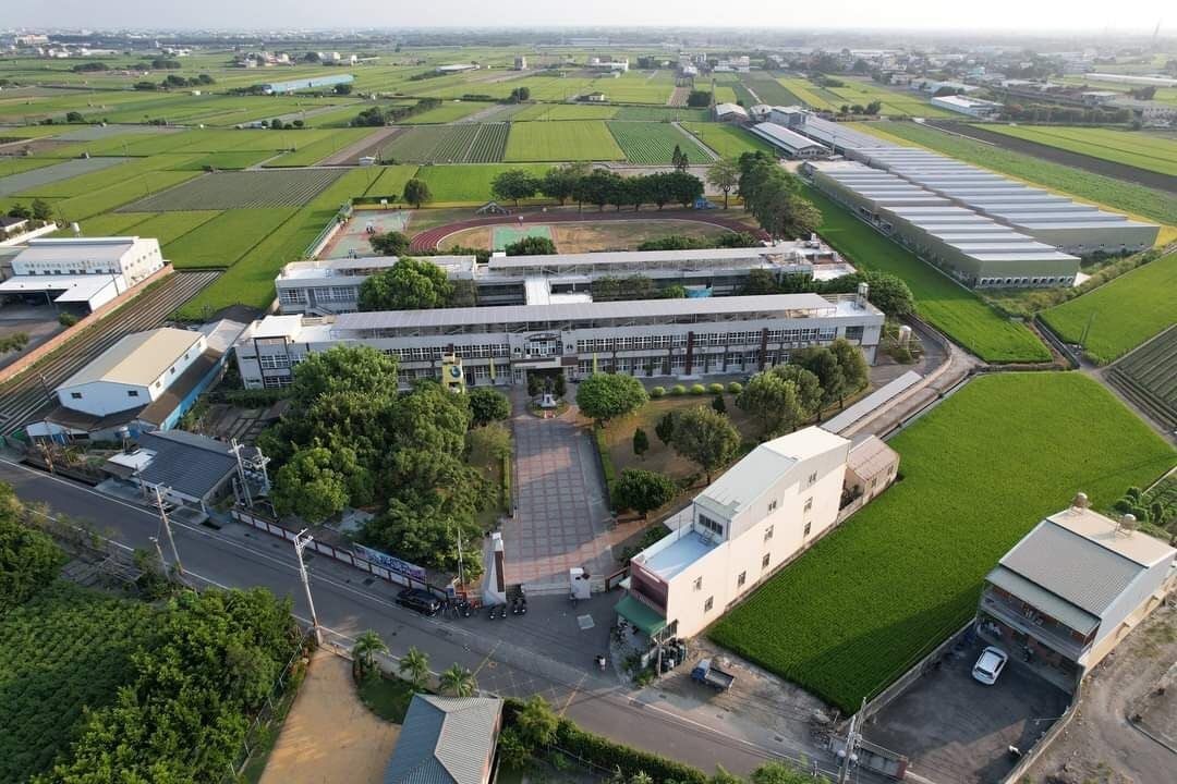 Aerial view of the campus among rice fields