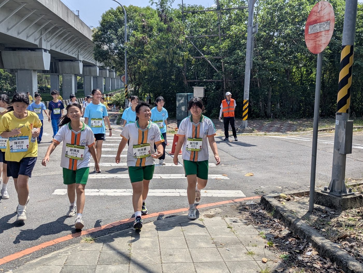Teachers and students running together.