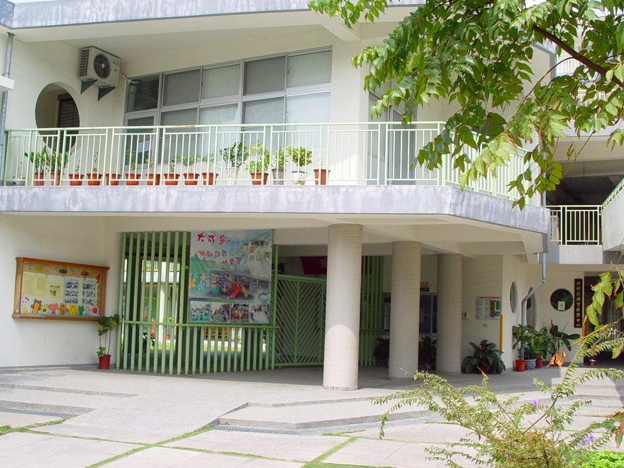 The kindergarten entrance with a painted banner above the gate