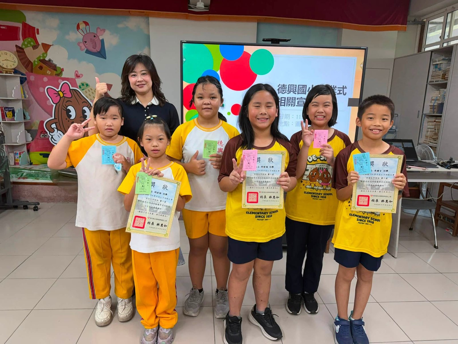 Students holding typing contest certificates
