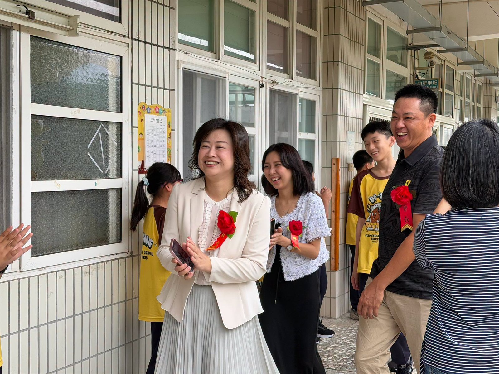 The principal and guests smiling together at the ceremony