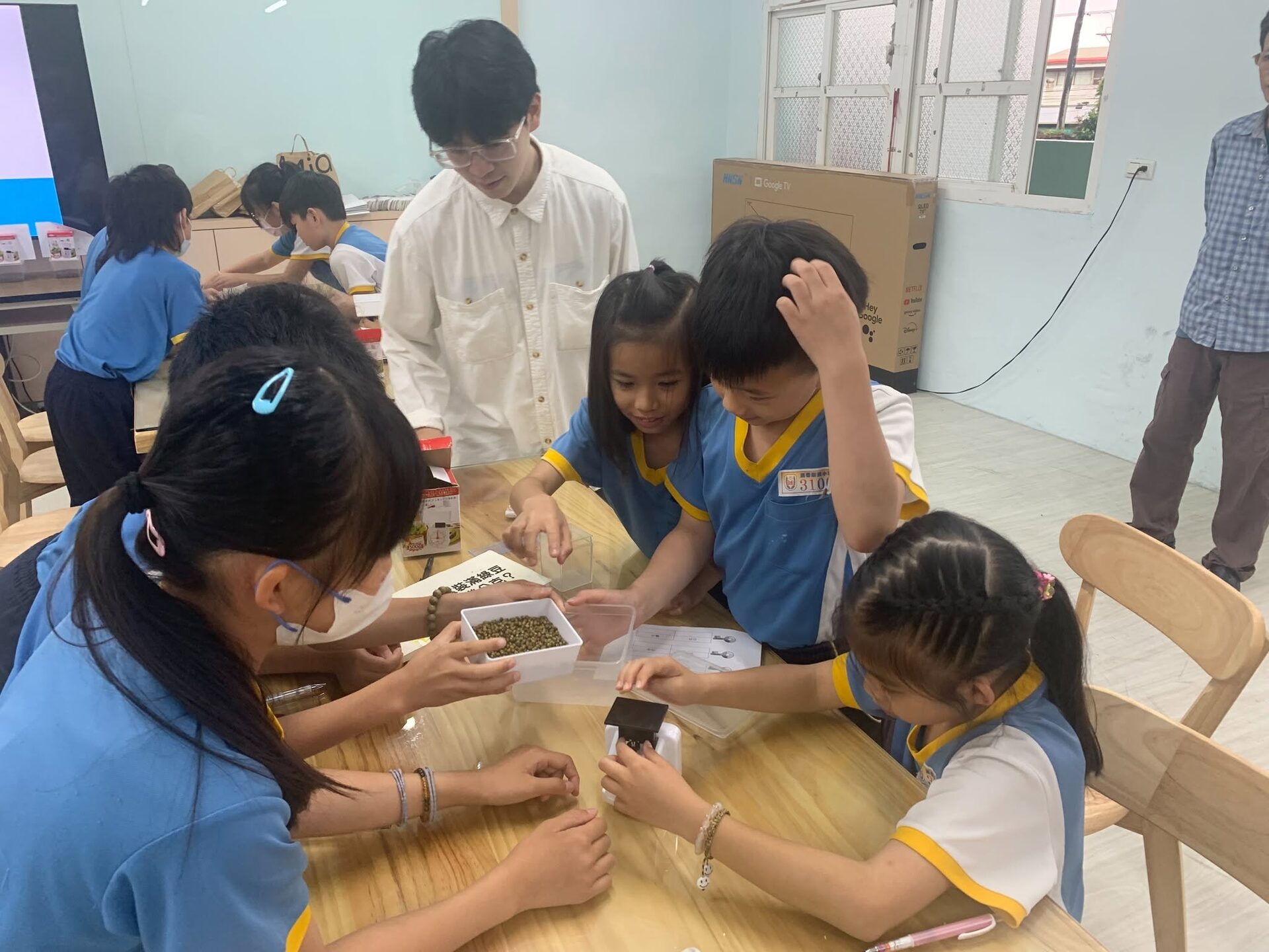 Students playing board games about weights and measures