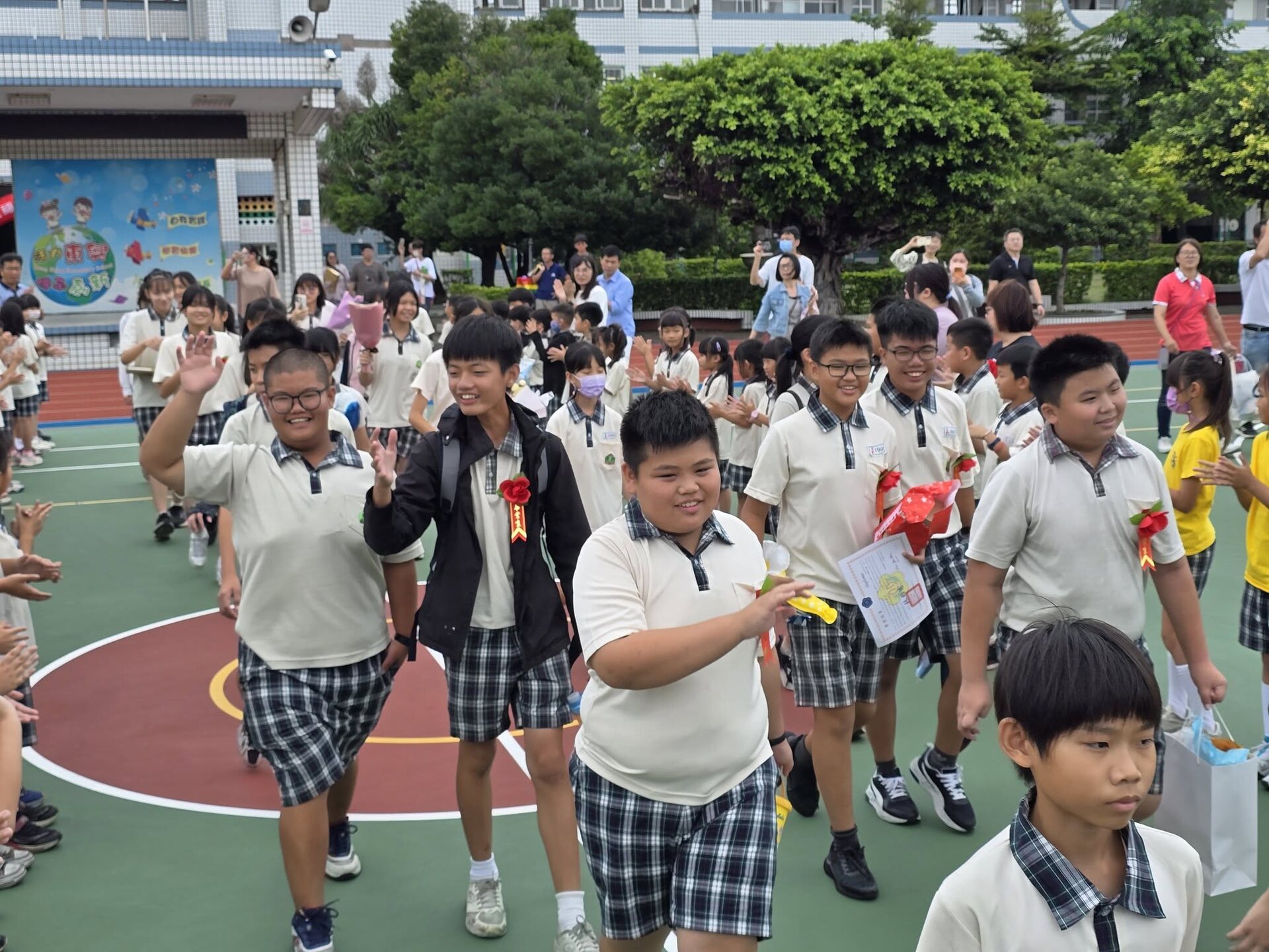 Dongshing graduates celebrating outdoors on graduation day