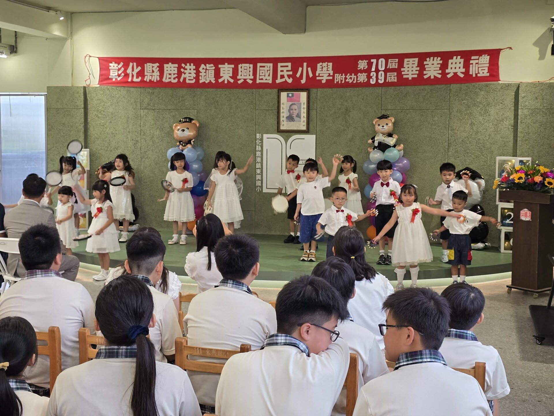 Kindergarten Penguin Class performing on stage at their graduation ceremony