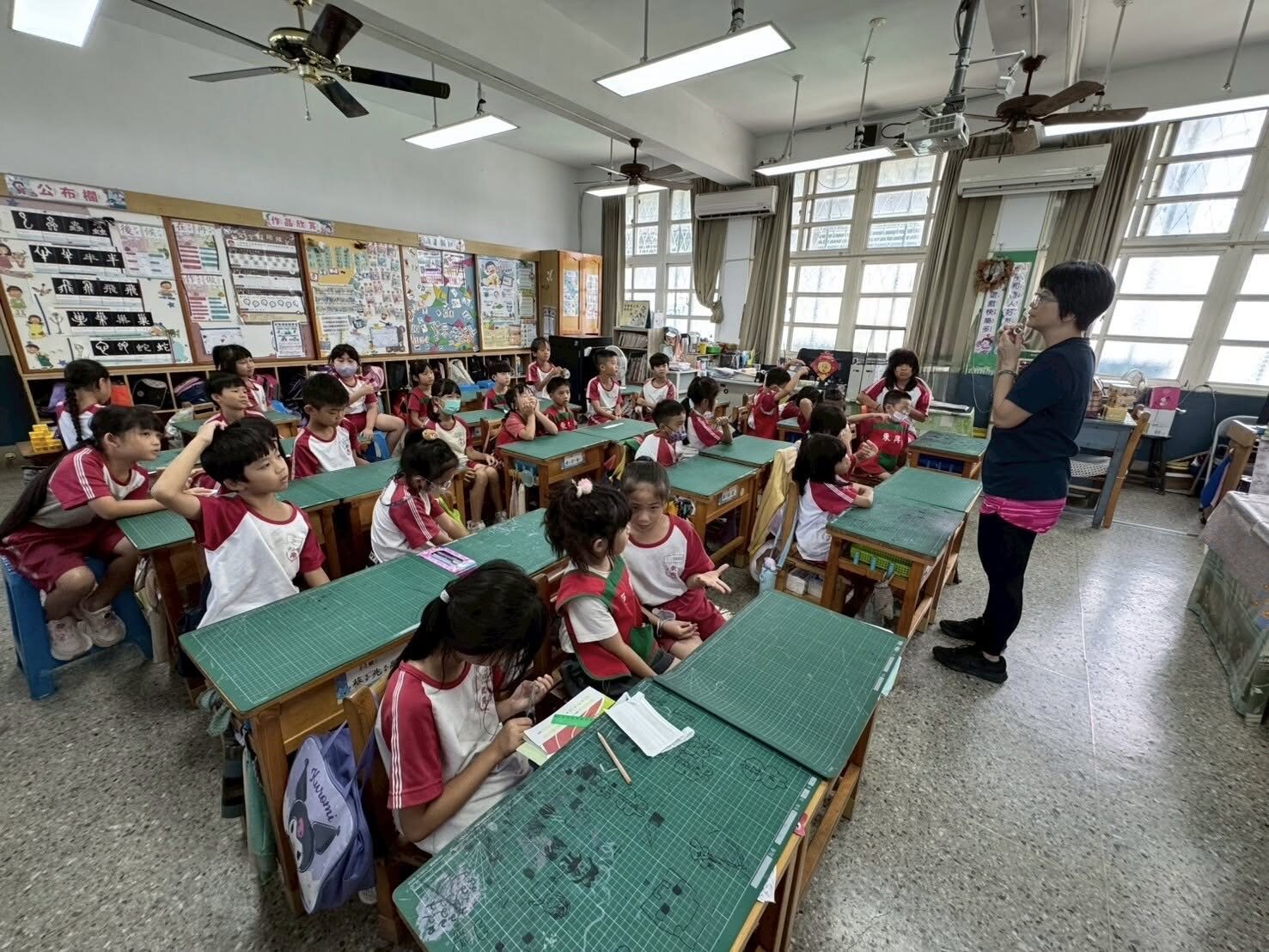 Penguin Class kindergarteners sitting in on a second-grade classroom