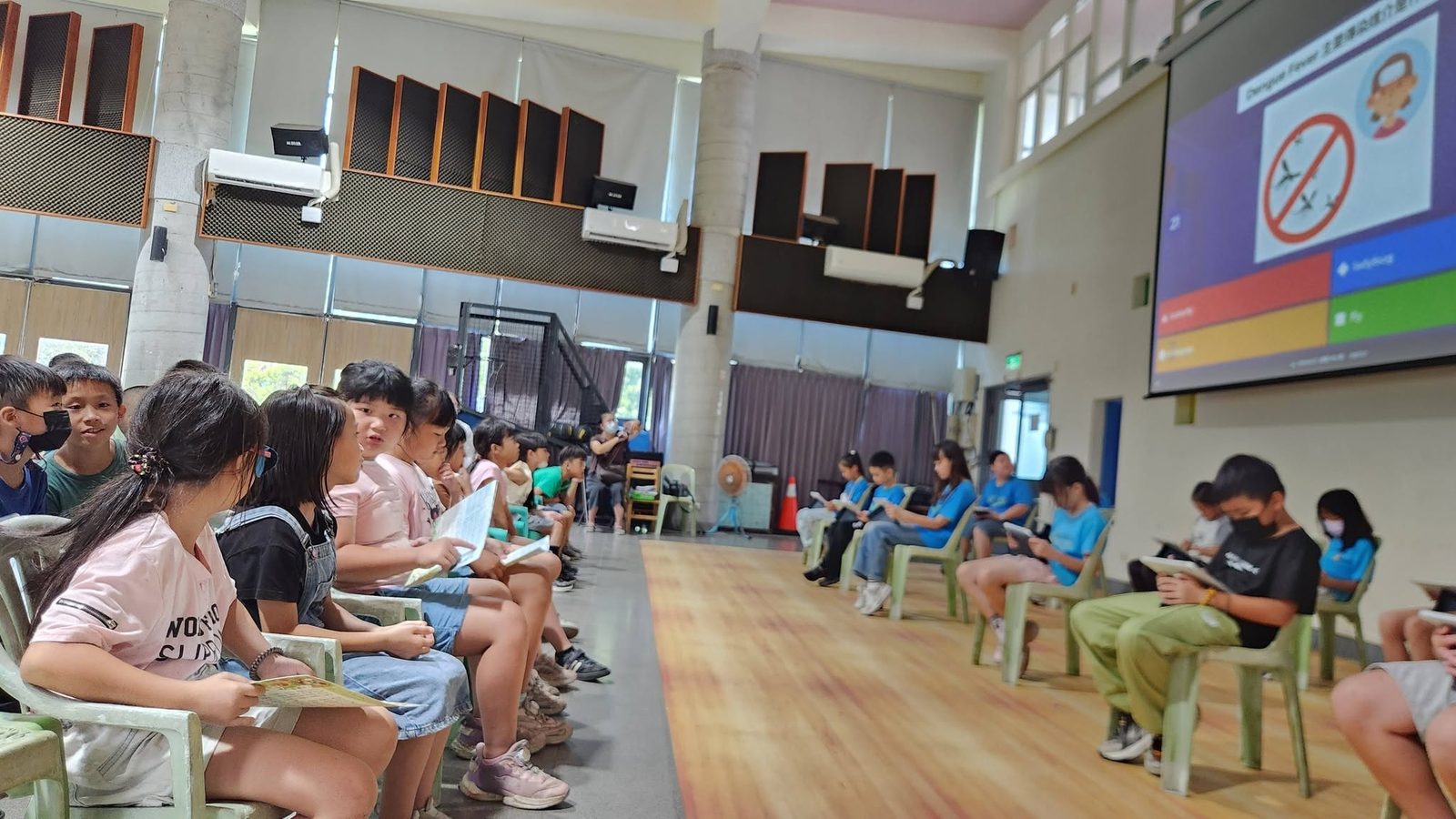 Students playing the Kahoot English contest on tablets