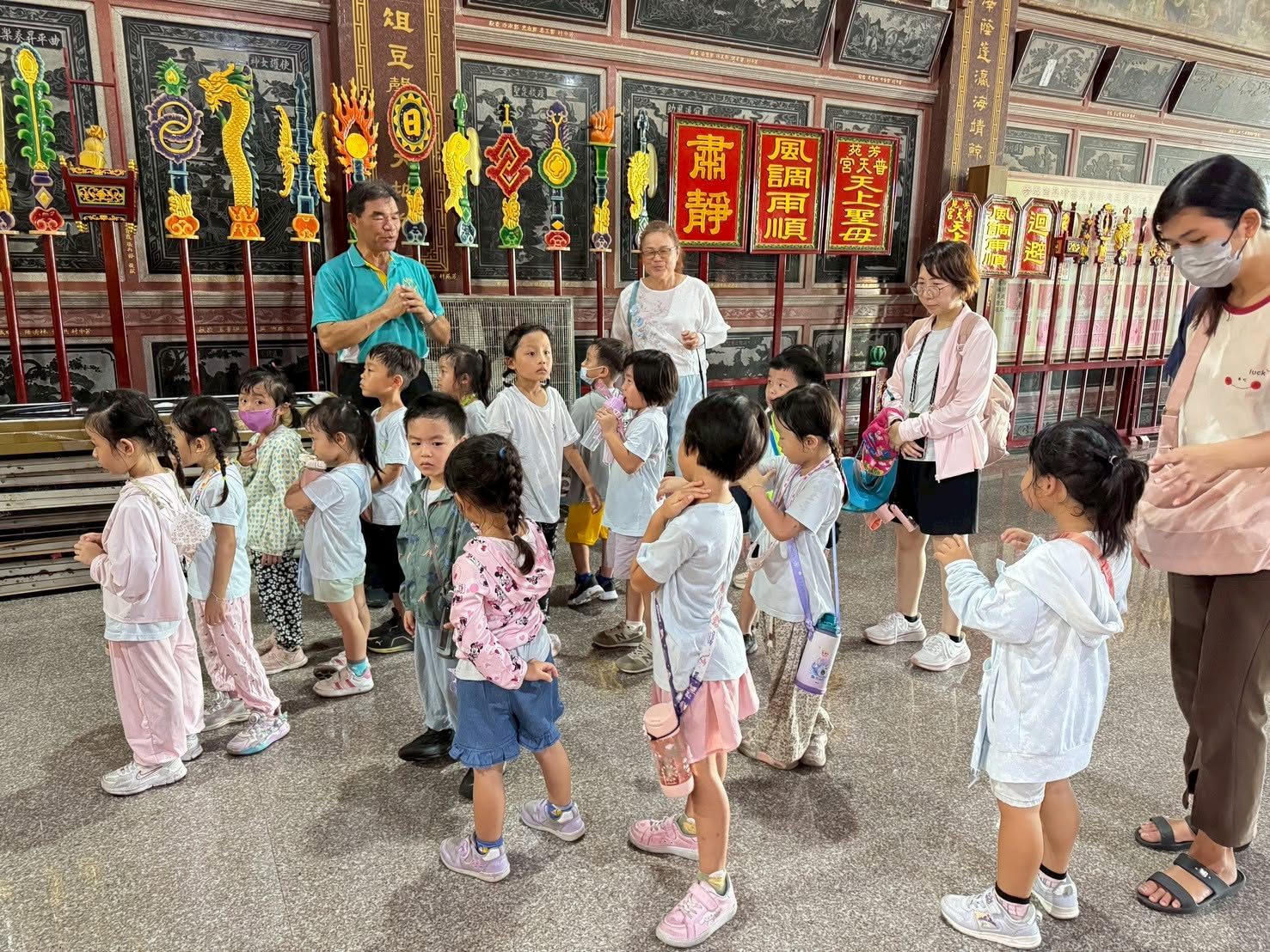 Kindergarten children listening to a temple guide