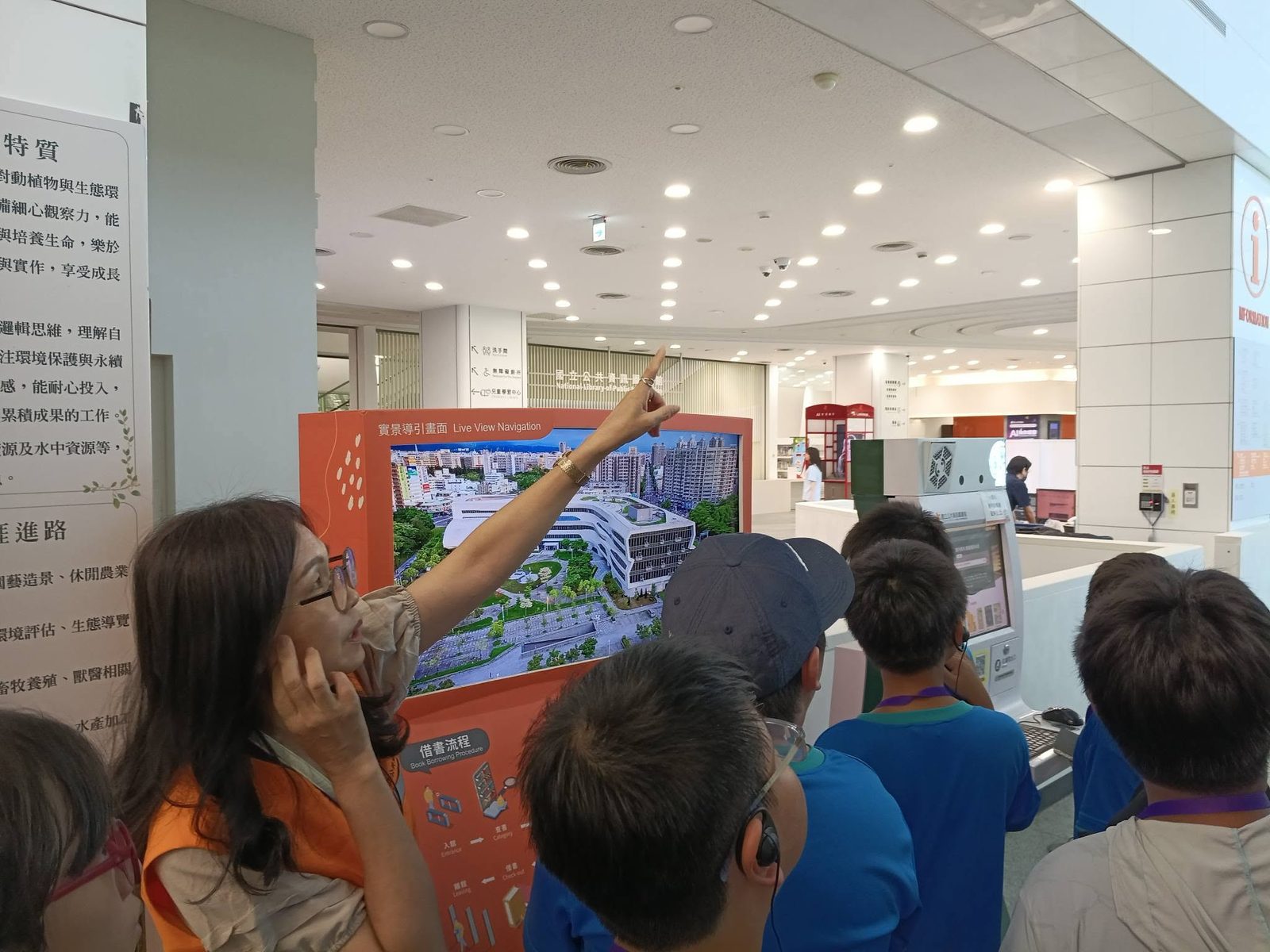 Students examining a large illustrated exhibit floor map