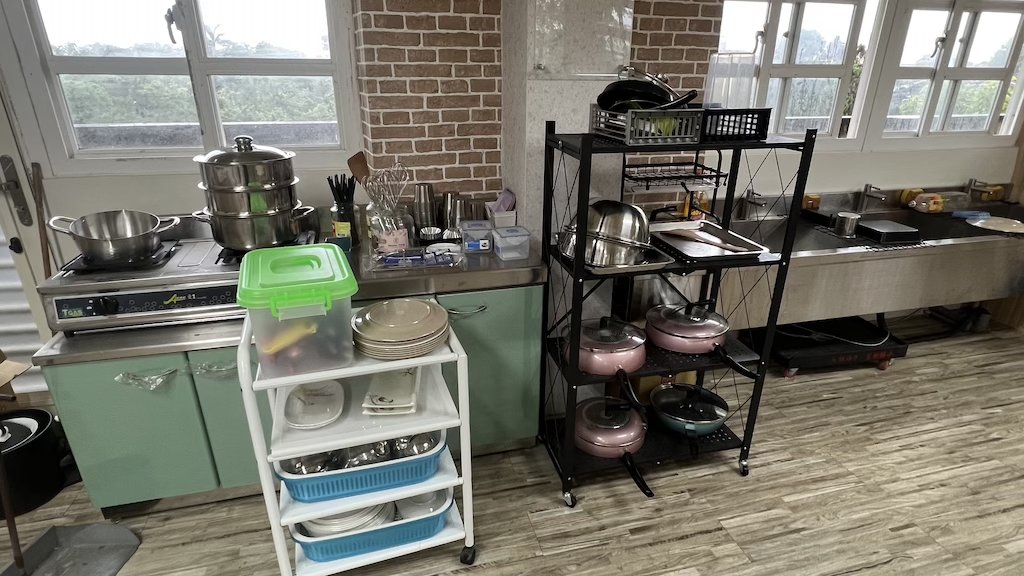 Food Lab kitchen area with pots, utensils, dishes, and a sink