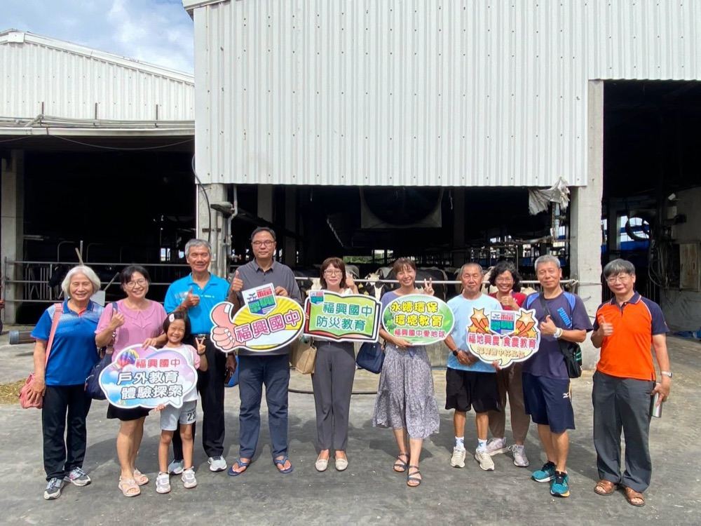 Group photo of teachers outside the ranch buildings