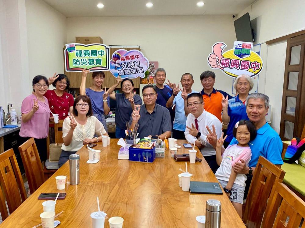 Fusing teachers gathered indoors with alumnus Huang before the tour