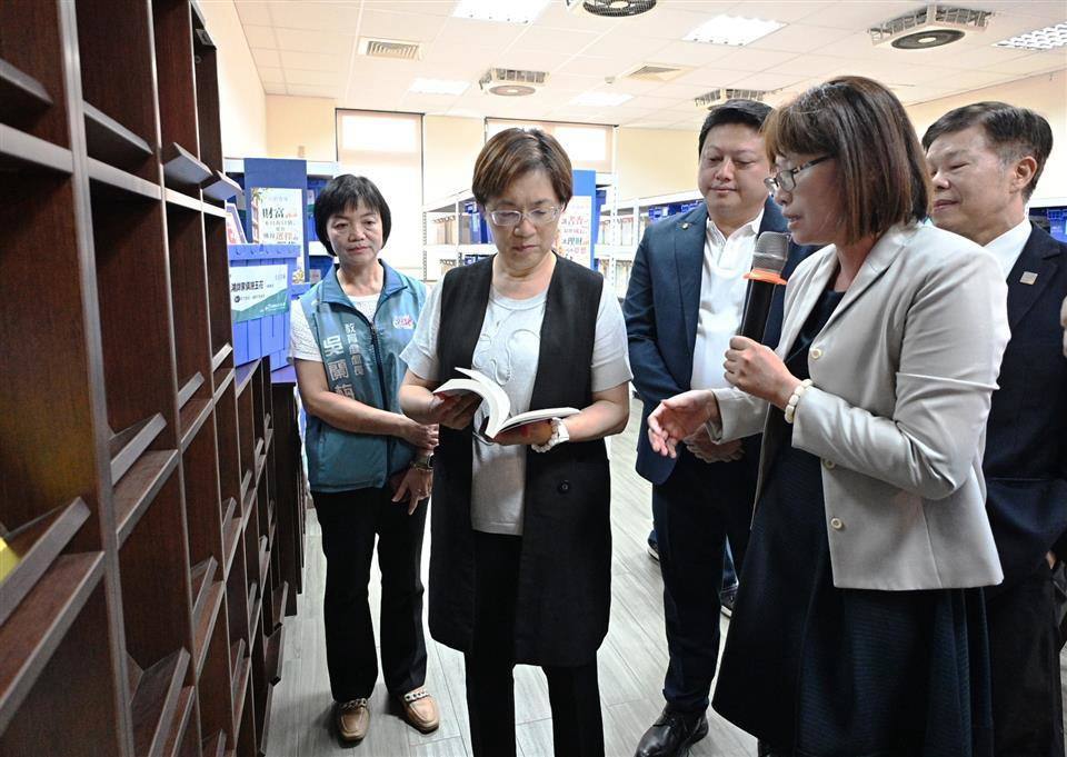 Guests browse the new bookshelves in the library