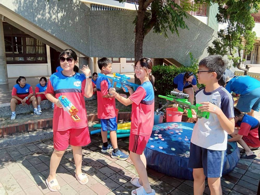 Students playing a water gun target game