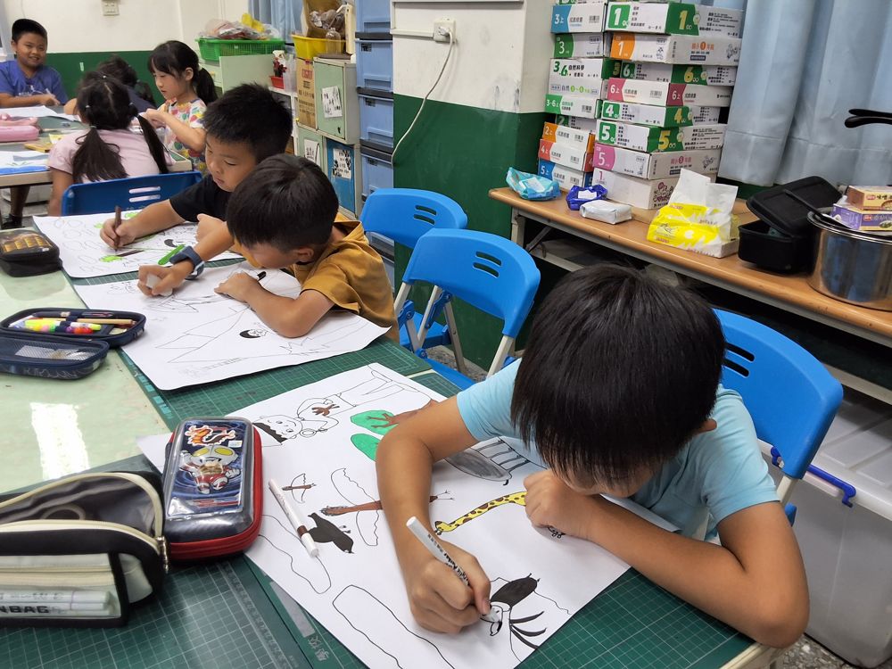 Students drawing and colouring in art class