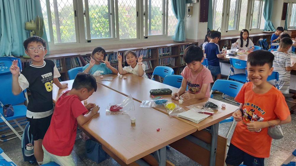 Students cutting and arranging paper for collage