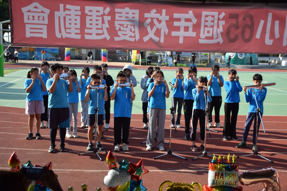 Harmonica club performing at the school anniversary sports day