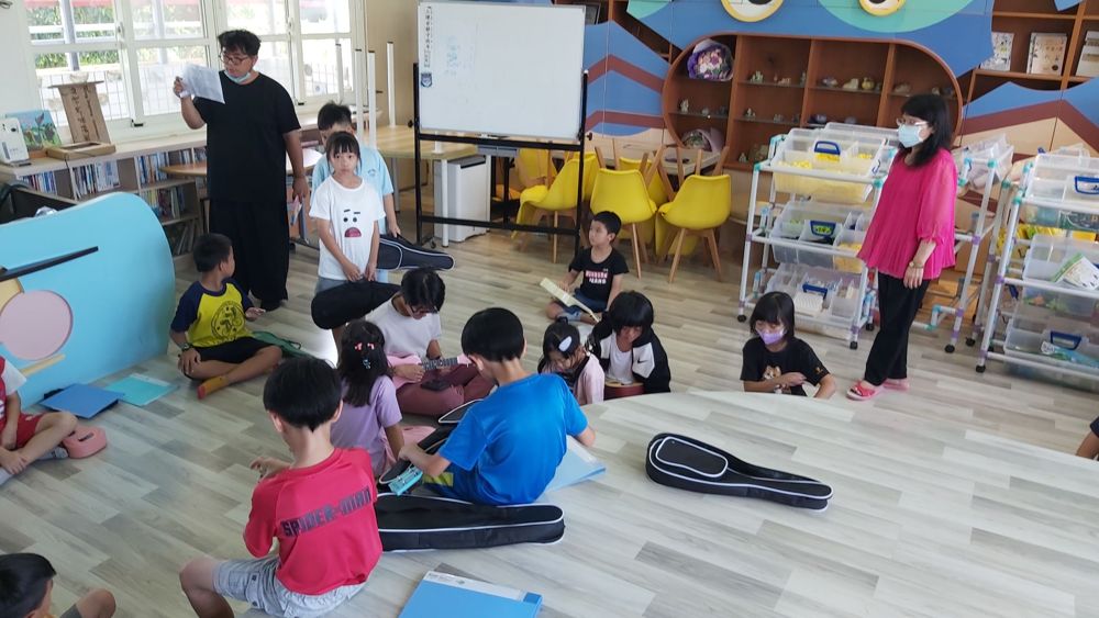 Ukulele club learning their first chords