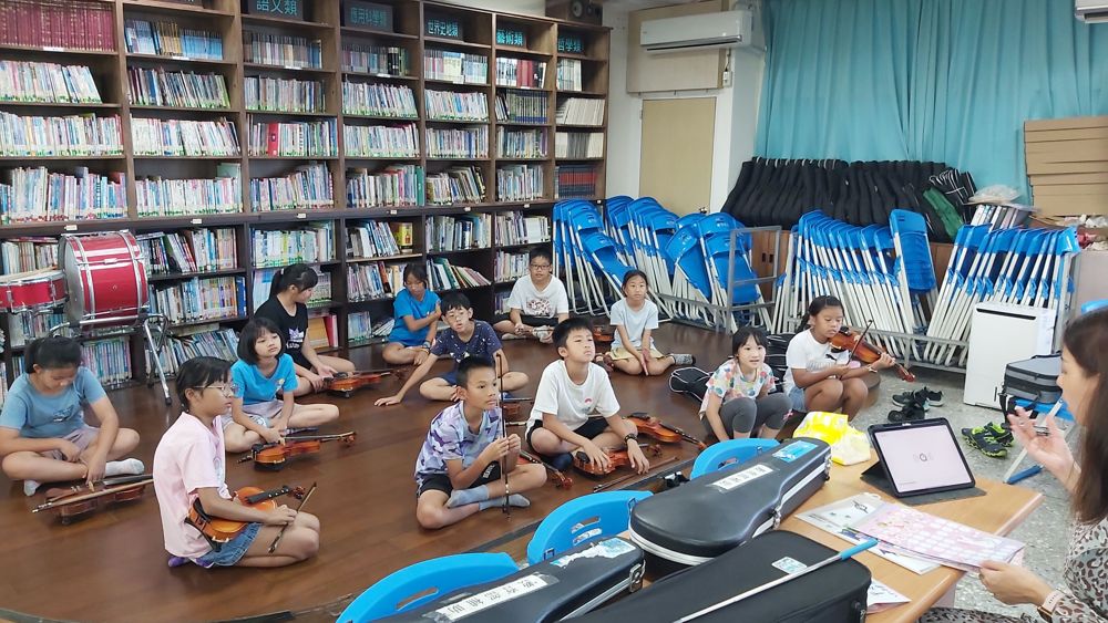 Advanced violin students rehearsing with the school piano