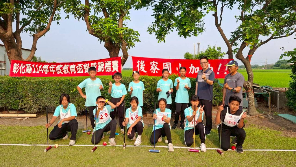 Houliao students with croquet team in front of rice paddies