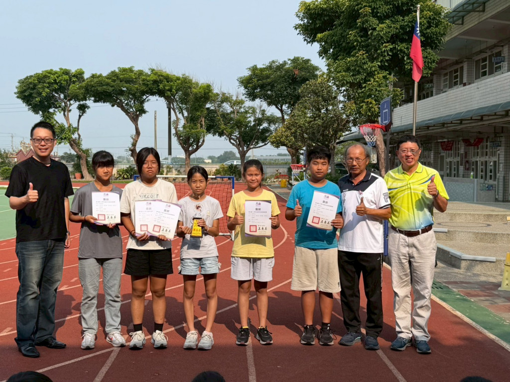 Students receiving inline-skate speed-racing awards on the school track