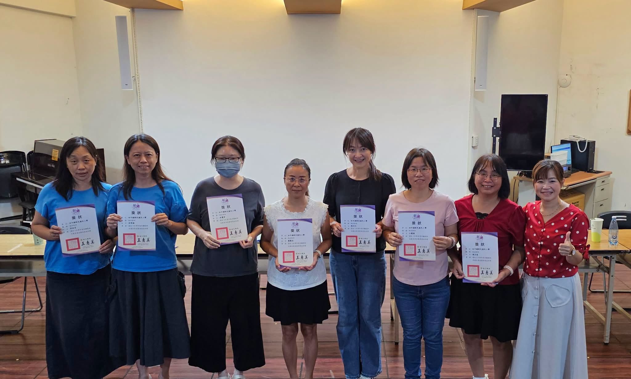 新民國小認輔教師團隊手持獎狀合影