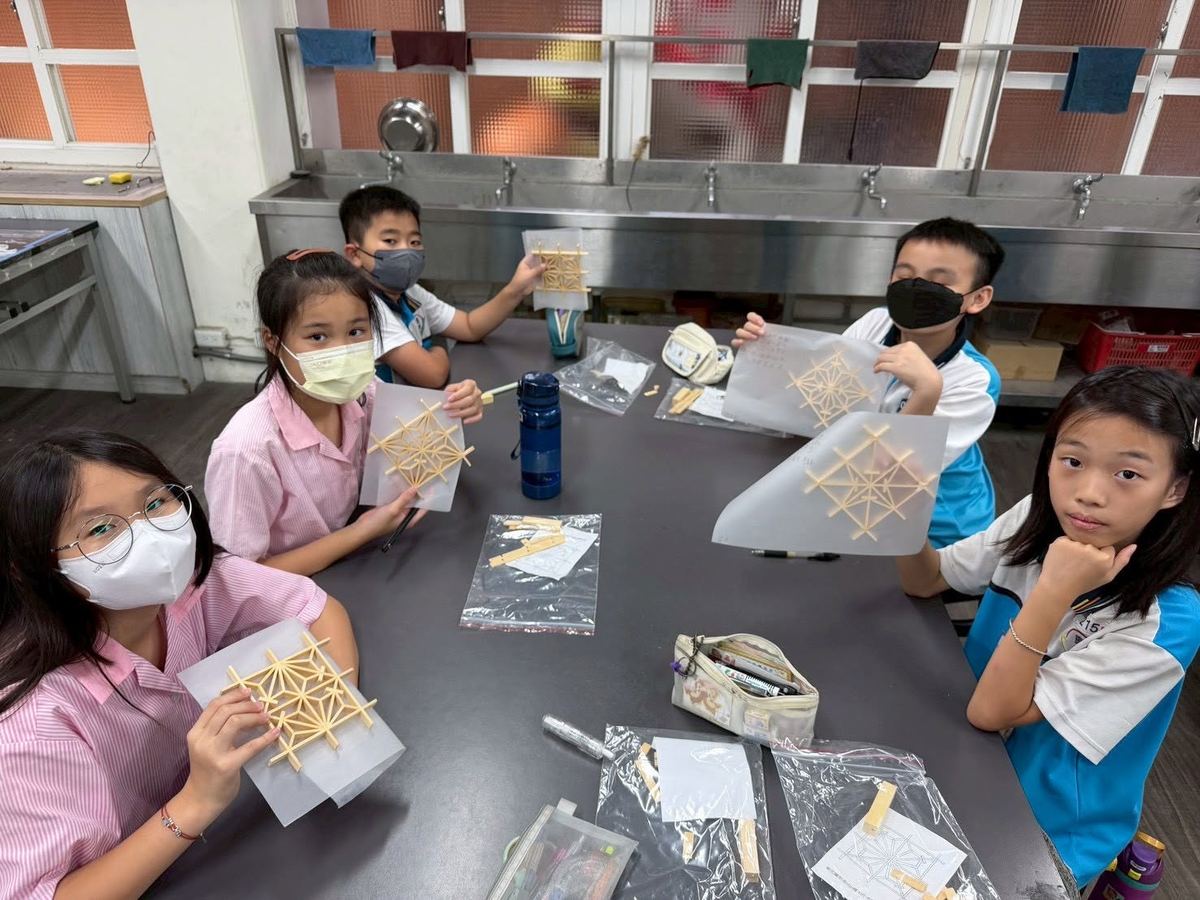 Students holding their handmade bamboo-lattice craft