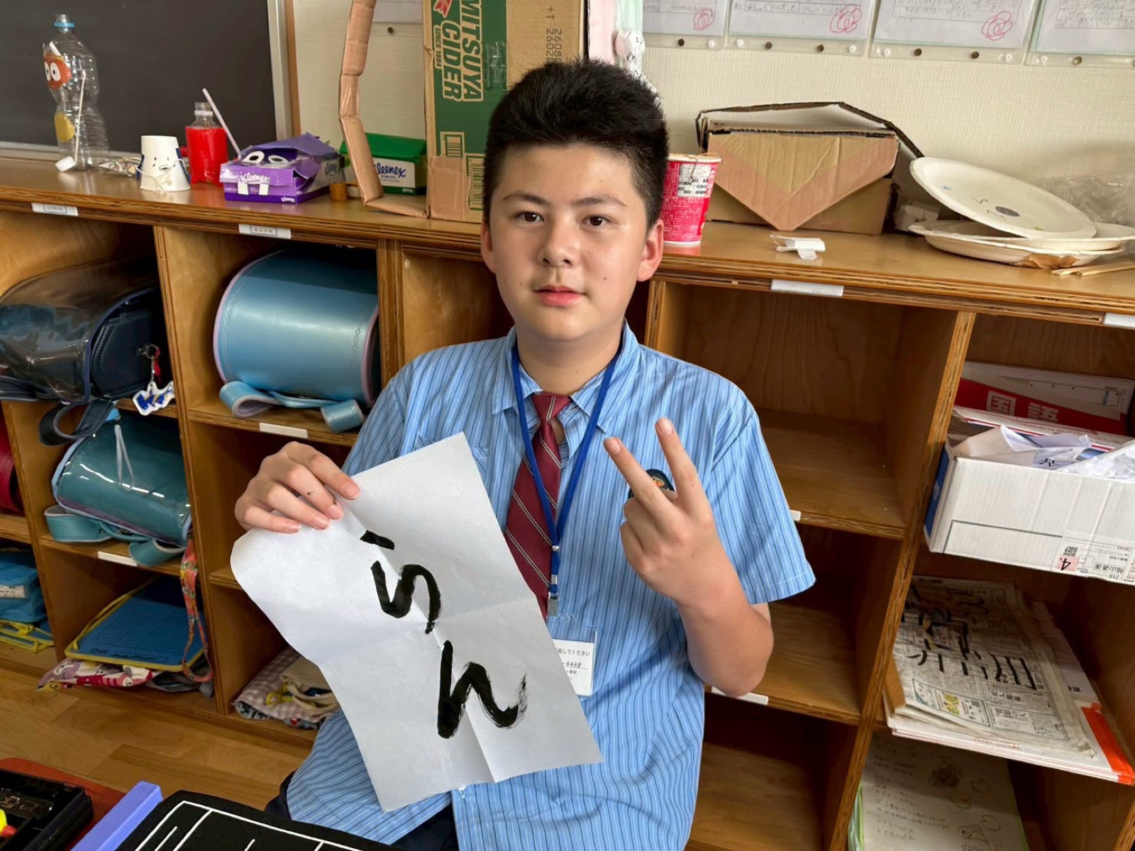 A Lushang student shows off his shodo calligraphy paper
