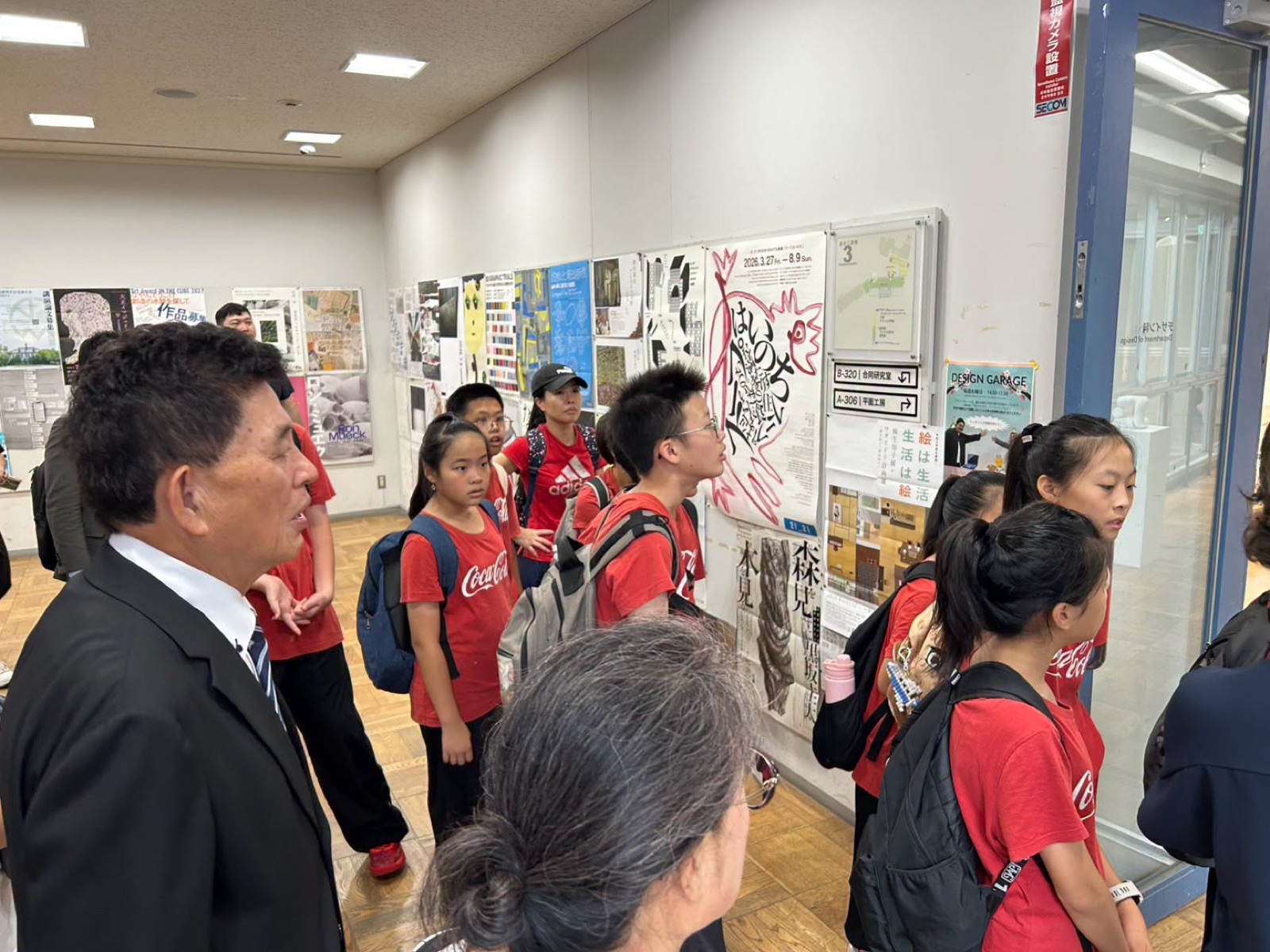 Students tour a corridor lined with student artwork