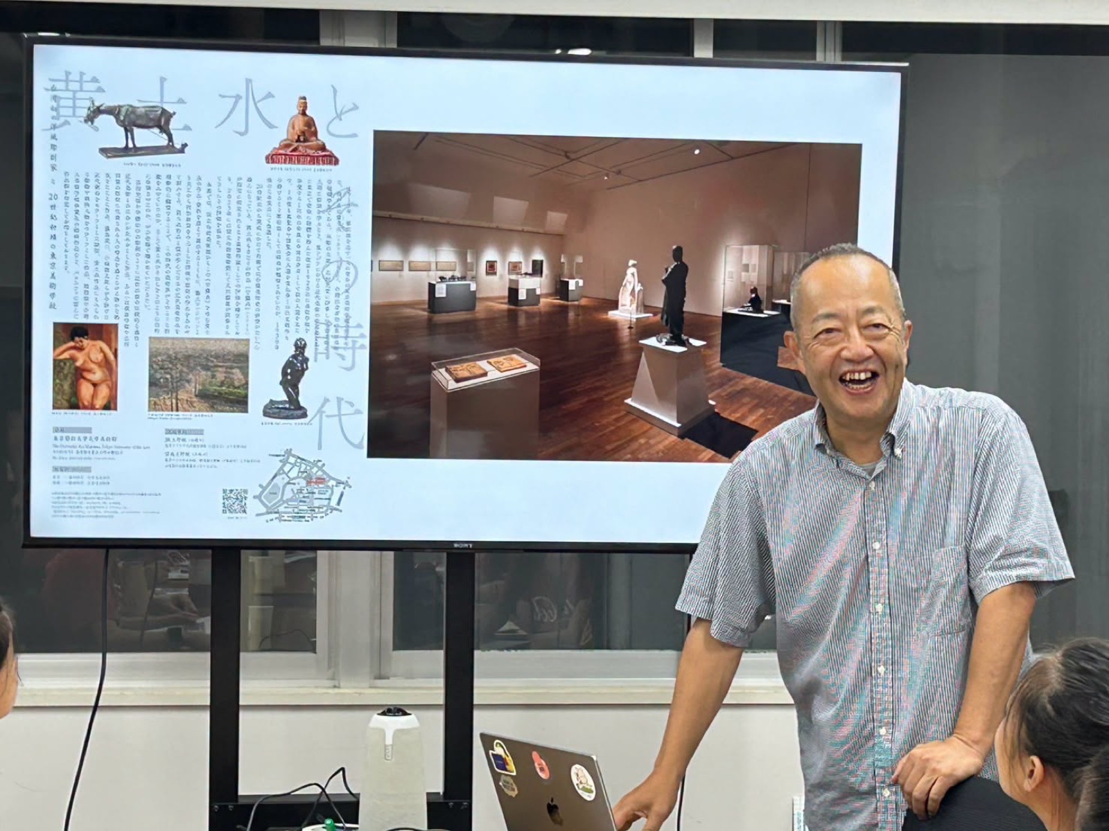 Professor Nagahama smiles while presenting a gallery exhibit