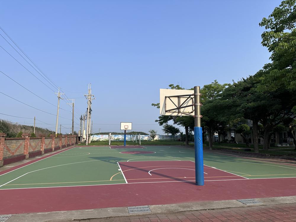 Outdoor basketball court under a clear blue sky
