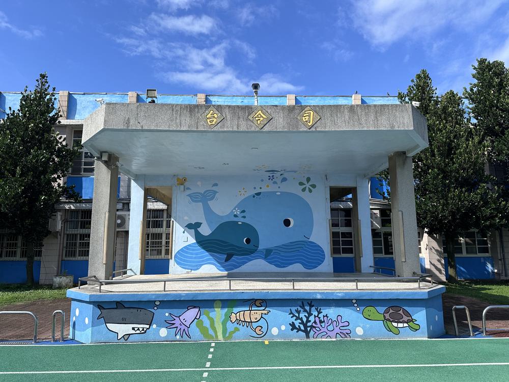 The assembly stage with its big blue whale mural