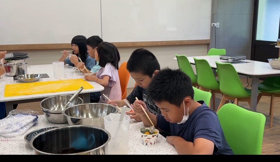 Students happily tasting their finished snack