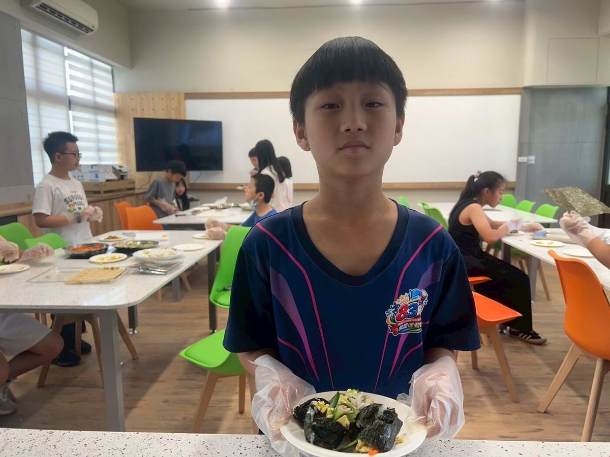 Students rolling their vegetable dish