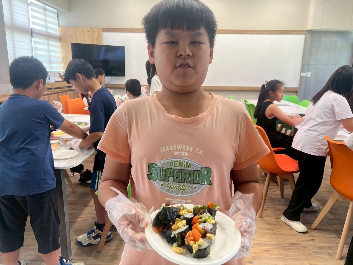 Student holding her finished dish