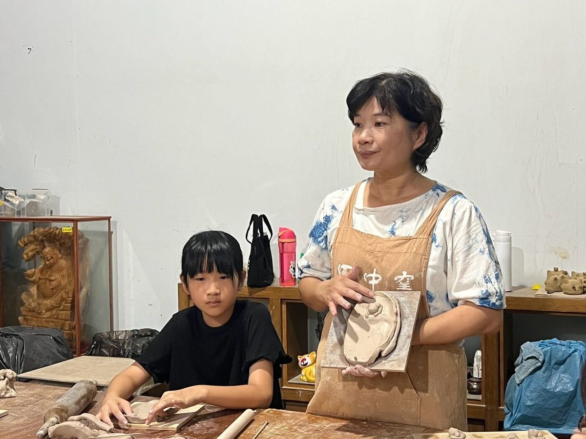 Students working with clay at a table