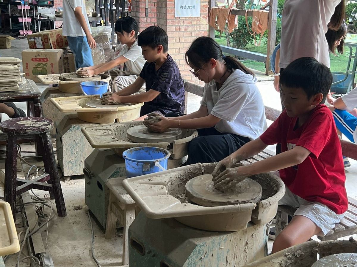 Teacher demonstrating on a pottery wheel