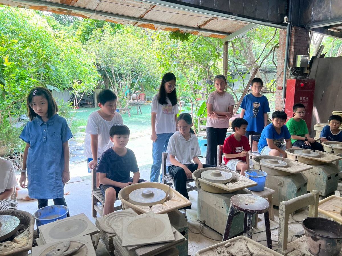 Students working with clay at a table