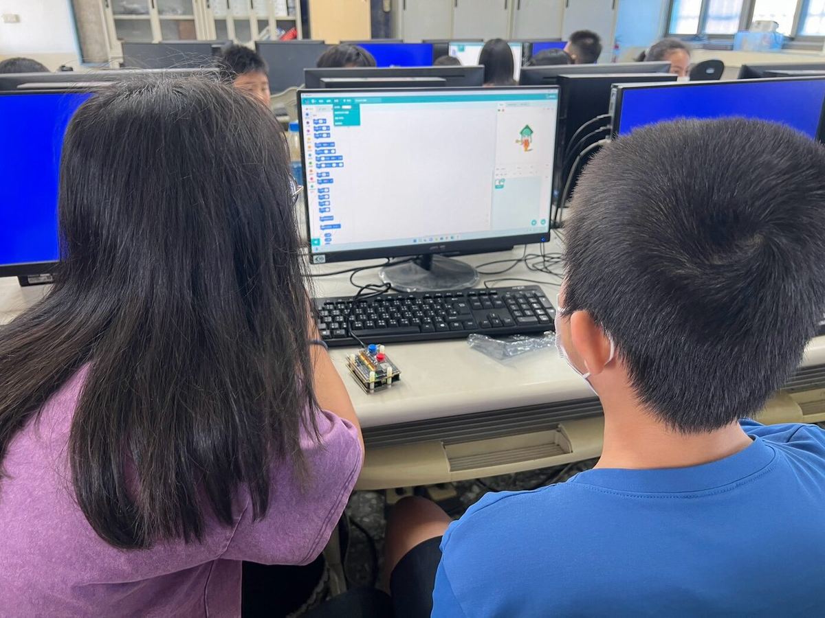 Students coding together at a computer