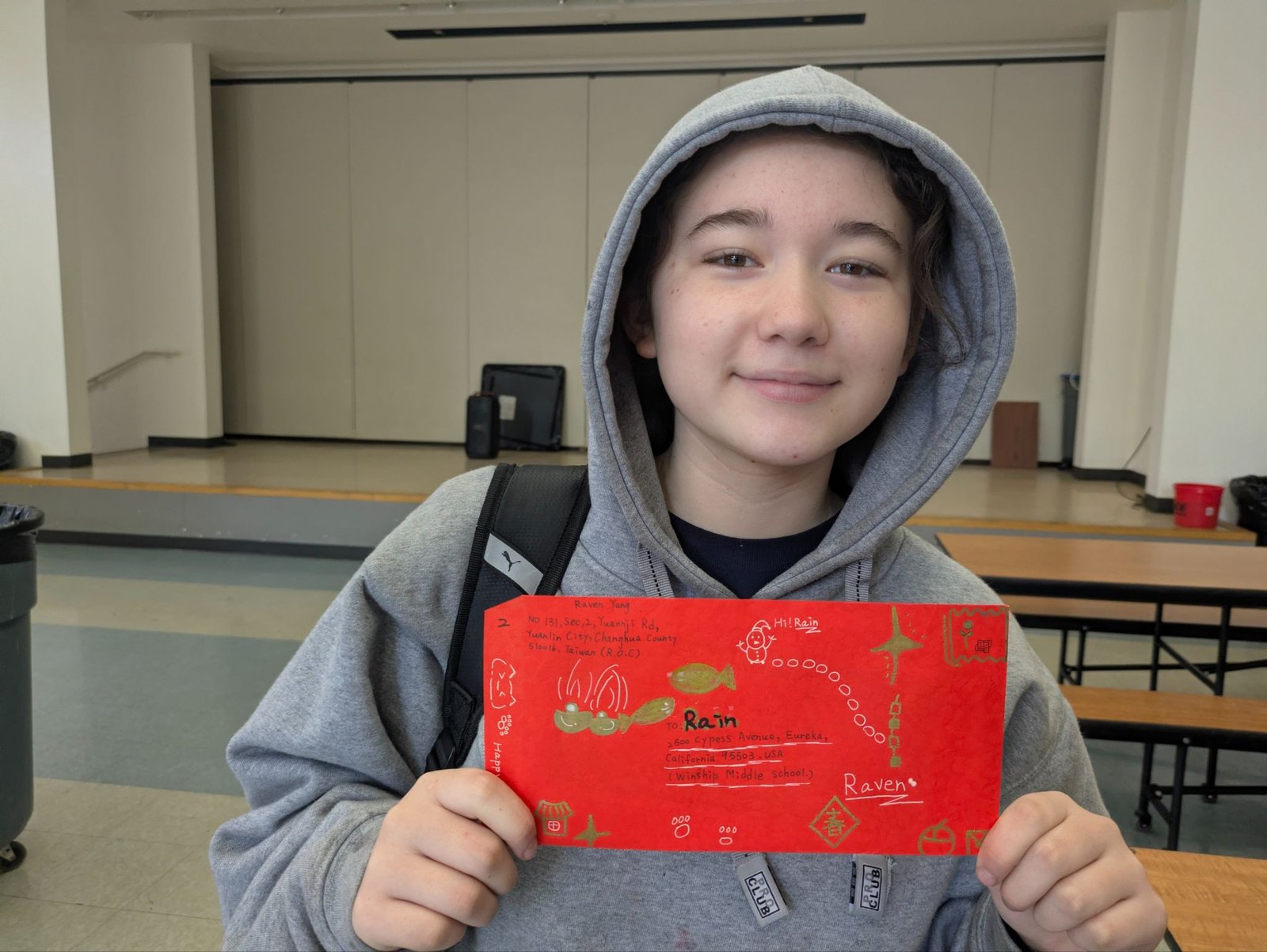 A Windship student shows a hand-decorated letter addressed to Raoming, Taiwan