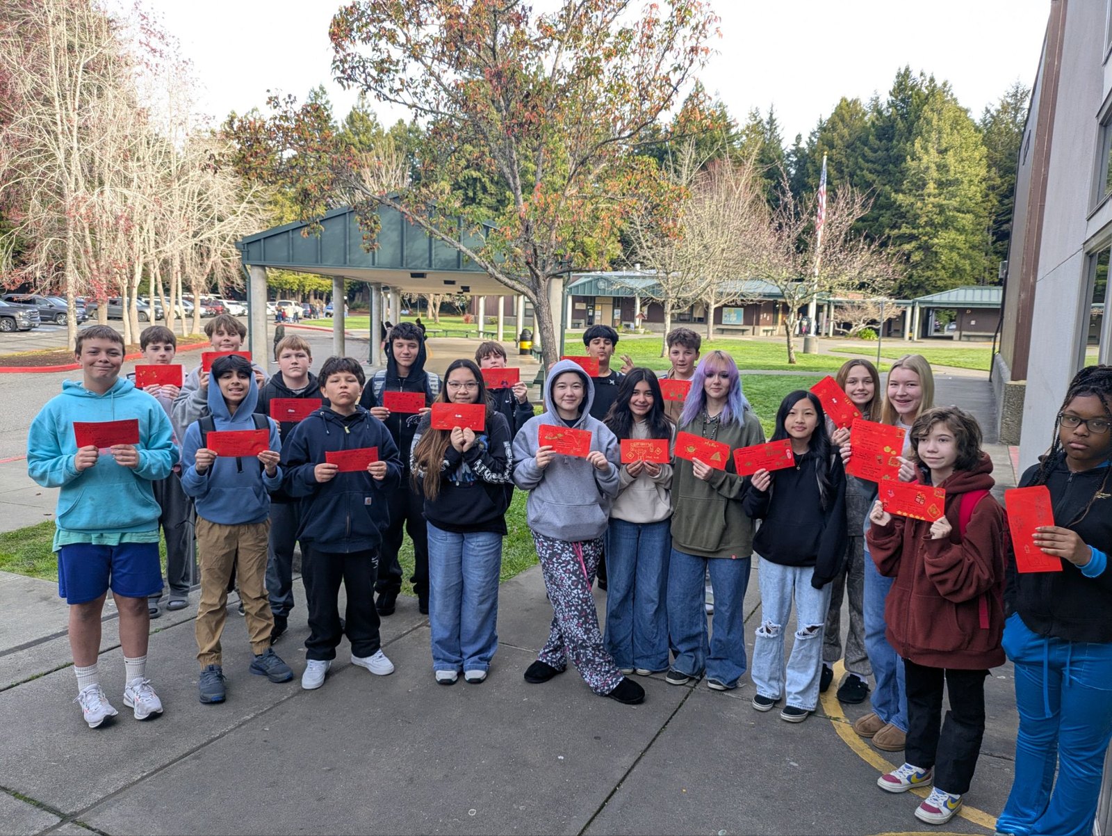 Windship students holding hand-decorated letters for Raoming