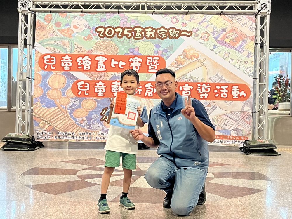 繪畫社學生在兒童繪畫比賽會場拿著獎狀合照 An Art Club student holding a certificate at a children's art contest