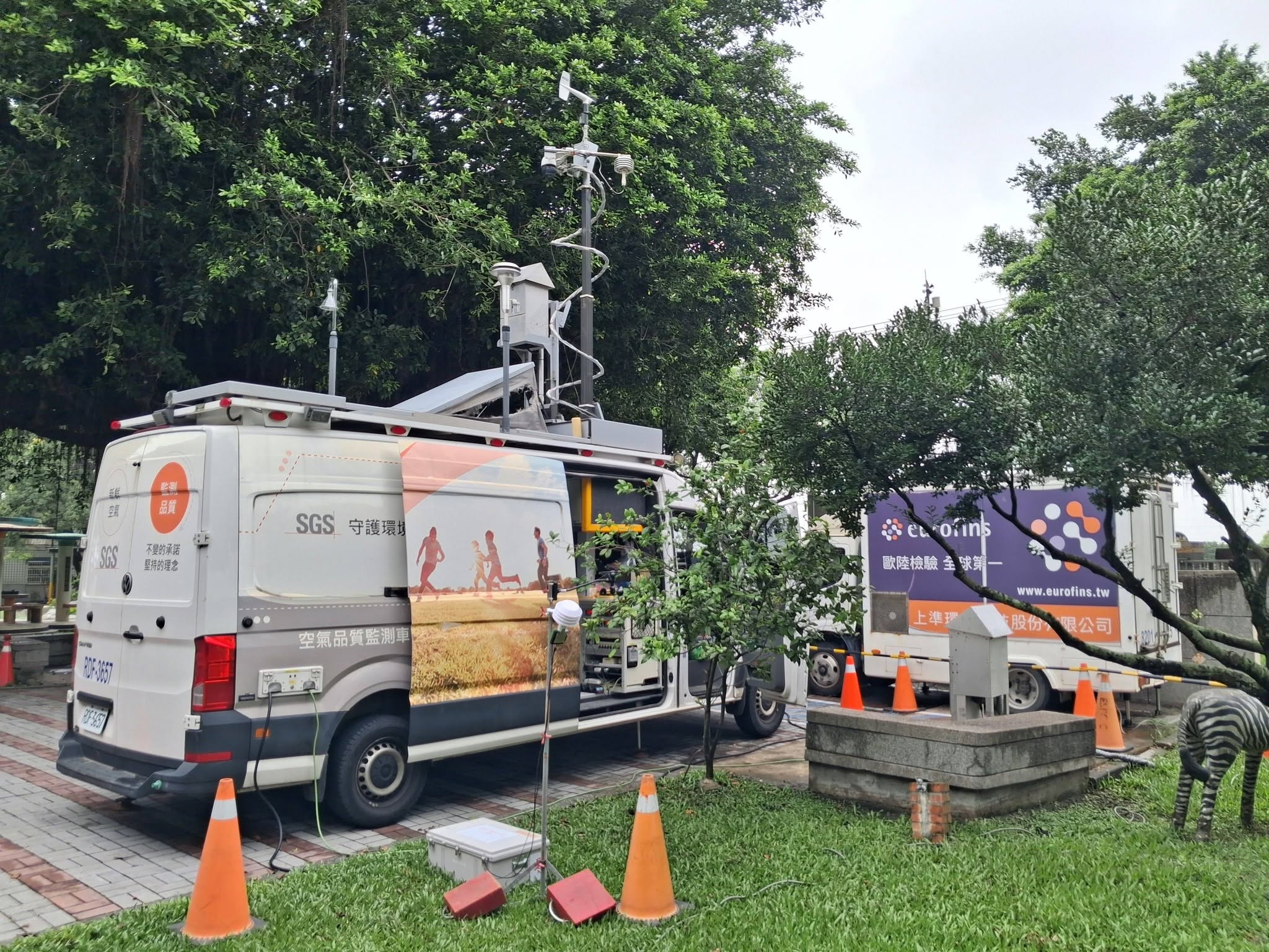 SGS monitoring van beside the Eurofins truck in campus grounds