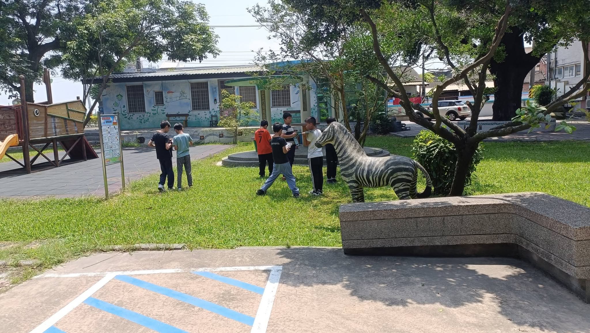 Students searching for clues near the zebra sculpture on campus