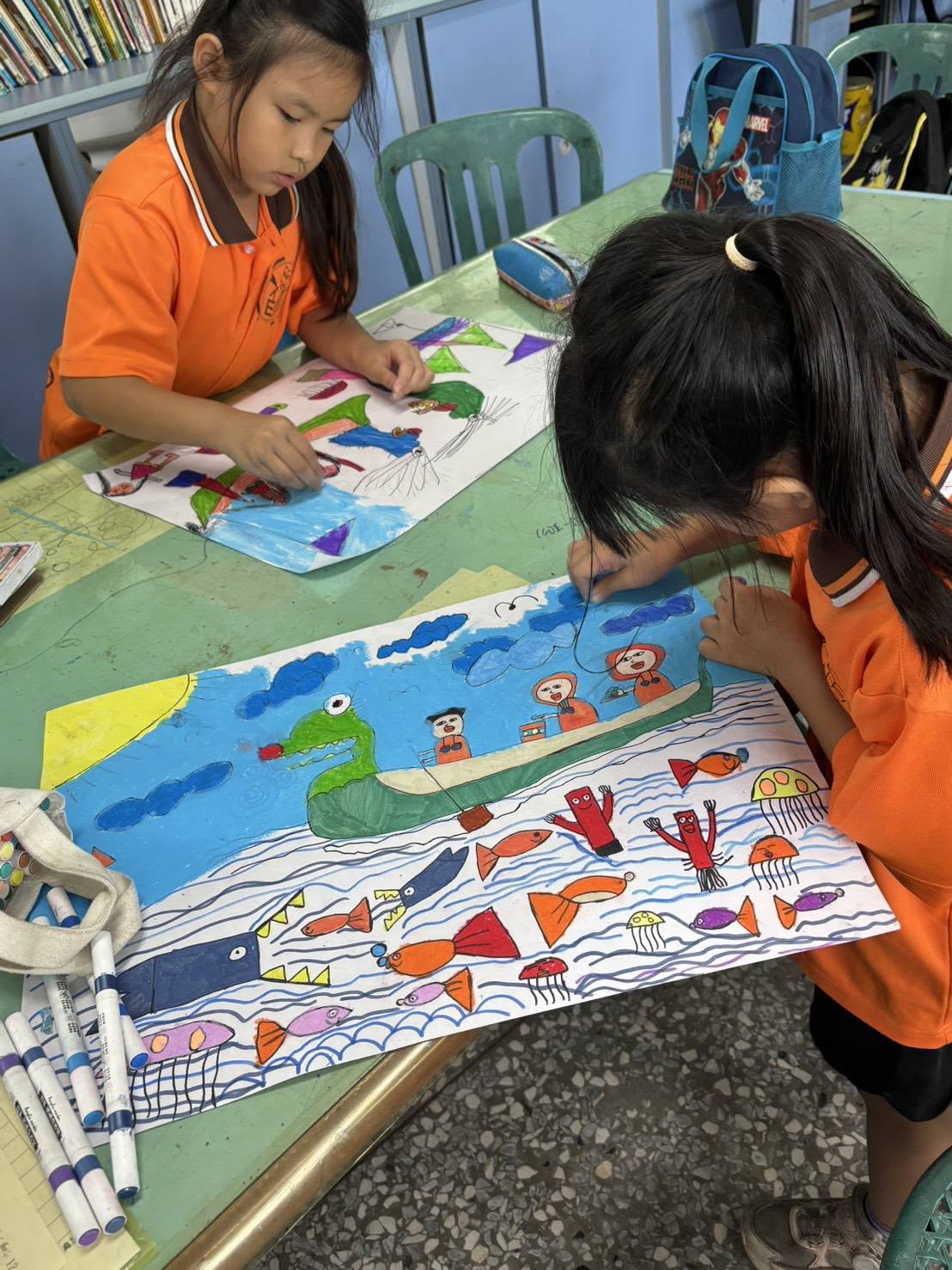 Two Tiantou students painting detailed dragon-boat scenes