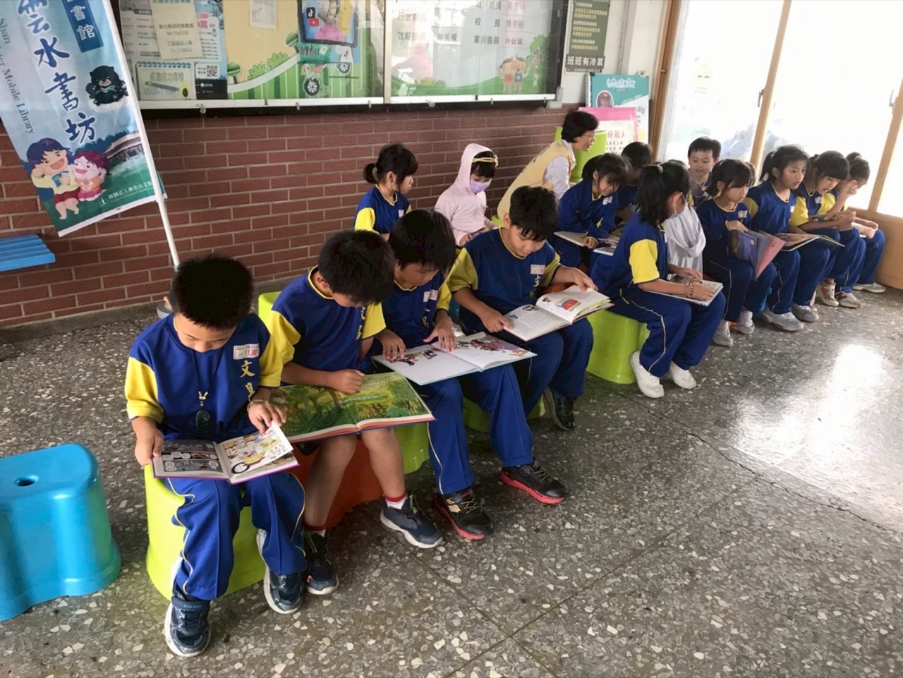 Children reading picture books together in the school library