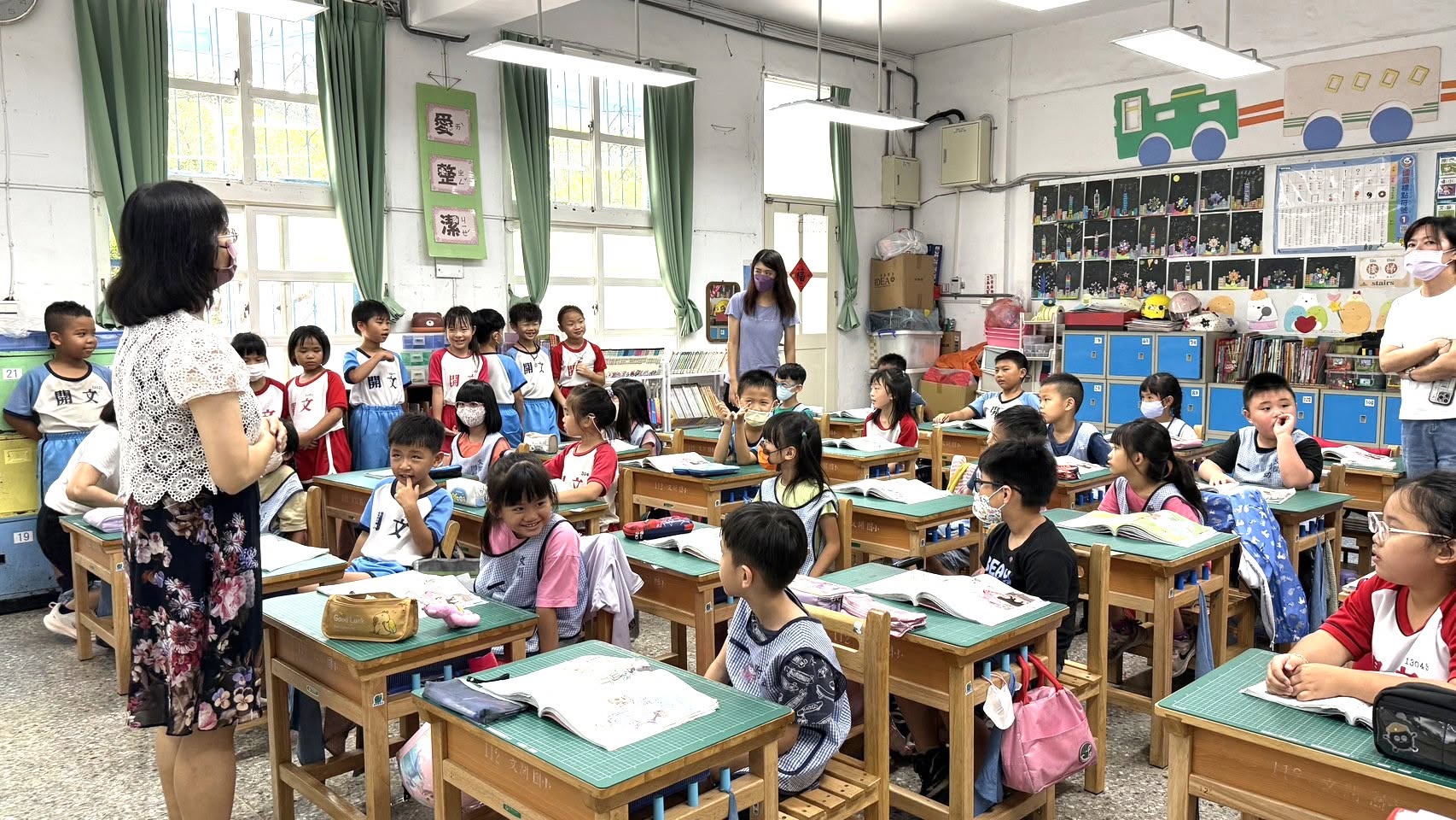 Kindergarten children observing an elementary classroom lesson