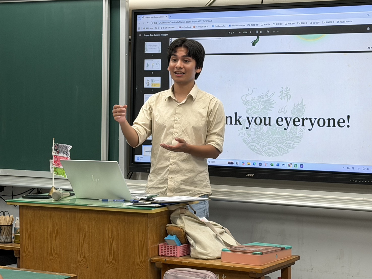 Teacher David Martinez teaching Dragon Boat Festival customs at Yangming Junior High, with 'Thank you everyone!' slide on screen