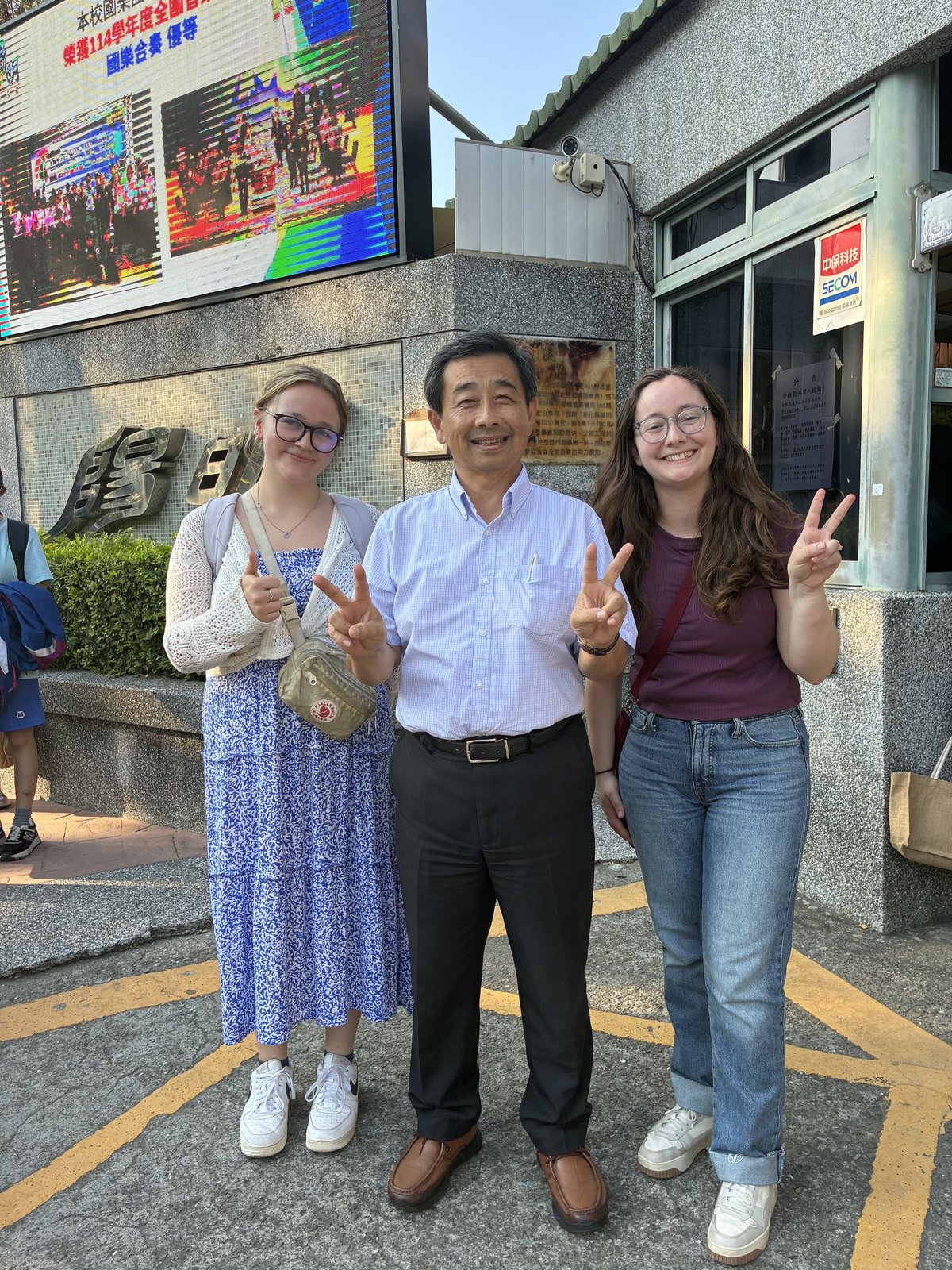 NMU student teachers Mila and Hannah with Principal Chang Yao-Chung at Yangming Junior High School, May 2026